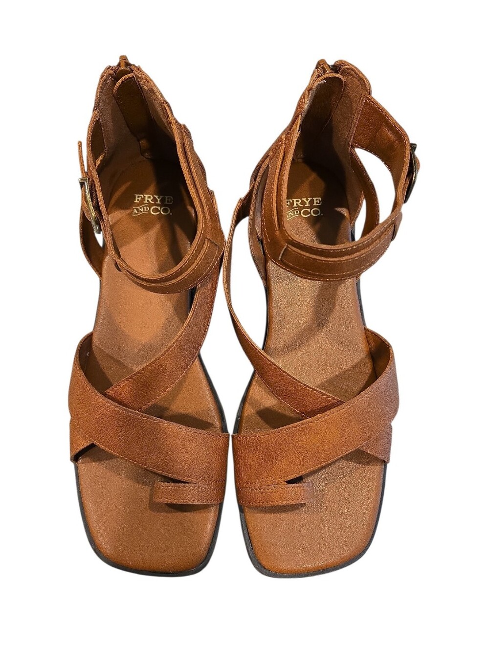 FRYE AND CO. " TALLU" SANDALS IN COGNAC W/ CRISSCROSS STRAPS AND A TOE LOOP.